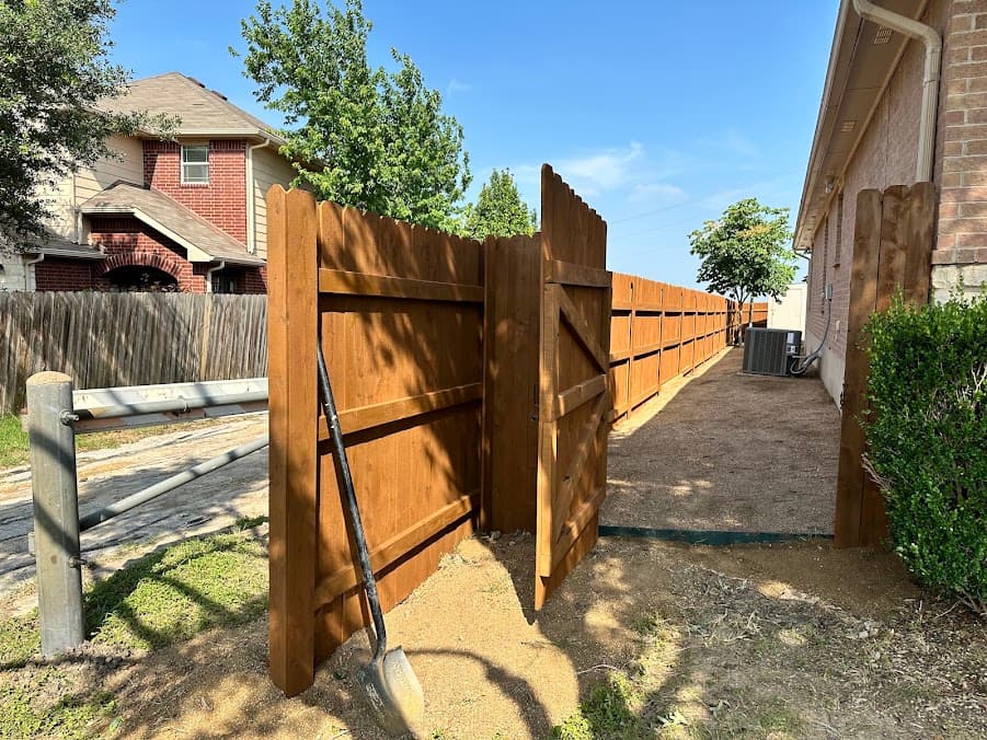 Completed cedar privacy fence with a new access gate